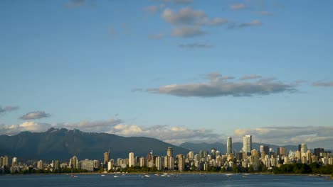 high-rise-buildings-of-modern-seaside-city,-yachts-and-ships,-from-the-ocean-side-against-the-background-of-mountains