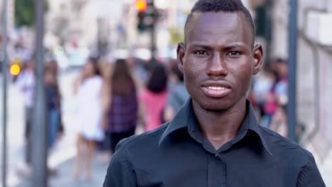 Confident-proud-black-african-man-smiling-at-camera---outdoor