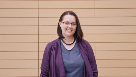 Young-Lady-Smiling-against-a-Beige-Background