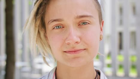 Young-Lady-with-Modern-Hairstyle-Smiling-Outdoors