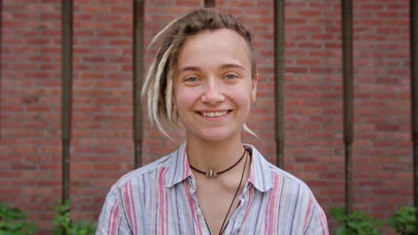 Young-Lady-with-Modern-Hairstyle-Smiling-Outdoors