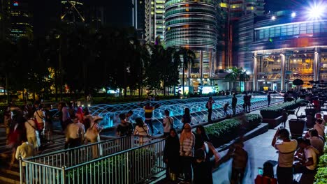 KUALA-LUMPUR,-MALAYSIA---May-15,-2018:-Fountain-at-night-with-peoples-near-Petronas-twin-tower-4K