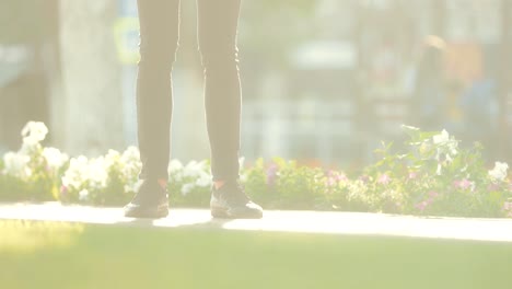 Close-up-of-the-legs-of-a-young-guy-who-is-waiting-for-someone-in-the-park