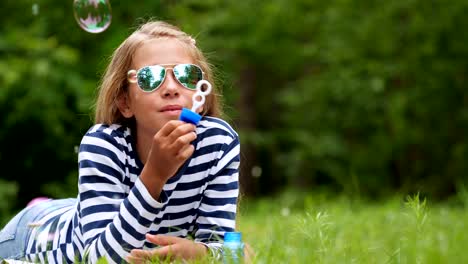 Little-girl-playing-with-soap-bubbles-outdoor.-Slow-motion.