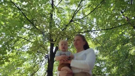 Mother-Holding-Baby-and-Walking-in-Park