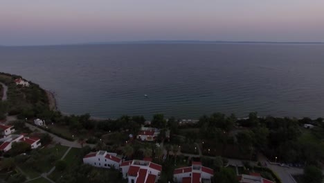 Aerial-scene-of-sea-and-cottages-on-the-shore.-Trikorfo-Beach,-Greece