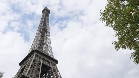 Lattice-construction-of-Eiffel-tower-and-symbol-of-France-in-front-of-cloudy-sky-4K