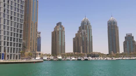 uae-sun-light-day-time-cayan-tower-dubai-marina-gulf-bay-4k