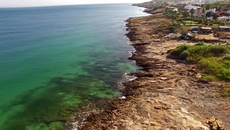 Beautiful-town-nead-ocean-rocky-beach-Lagos,-Praia-da-Luz,-Algarve,-Portugal