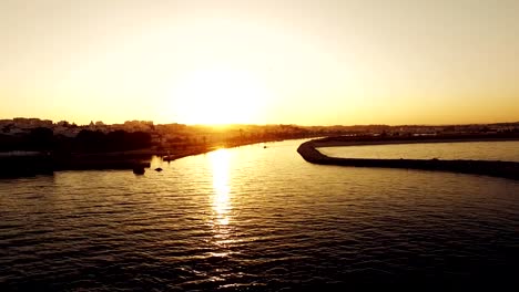 Boat-floats-on-the-marina-at-sunset-aerial-view