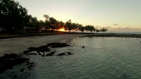 Vista-aérea-de-la-costa-de-Mauricio-y-puesta-de-sol-sobre-el-océano