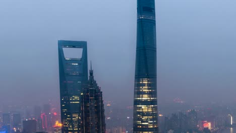 Time-lapse-of-Shanghai's-three-tallest-skyscrapers,-the-Shanghai-World-Financial-Center,-the-Jin-Mao-Tower,-and-the-Shanghai-Tower-at-sunset