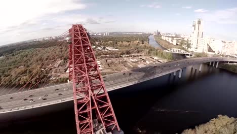 Aerial-helicopter-view-of-Zhivopisnyi-Most-(trsl.-Picturesque-Bridge)-over-Moscow-River.-Moscow-Russia.-Zhivopisny-Bridge-is-a-cable-stayed-bridge-that-spans-Moskva-River-in-north-western