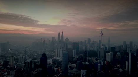 Burning-sky-against-Kuala-Lumpur-skyscrapers-with-fog-and-misty-morning.