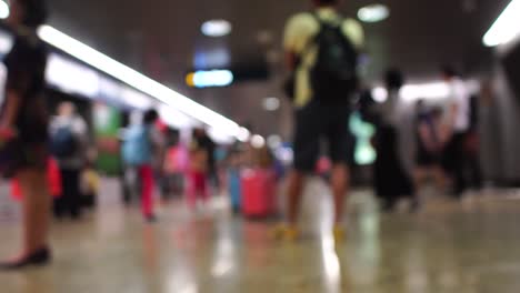 Travelers-passengers-in-airport-transit-terminal-walking-with-luggage-baggage-going-traveling.-Business-travel-people-out-of-focus-and-blurry-in-background-:-4k