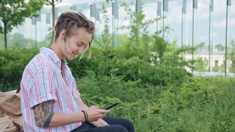 Young-Lady-with-Modern-Hairstyle-Using-Phone-in-Town