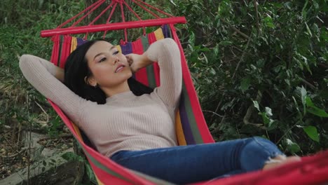 Beautiful-young-woman-lying-down-to-hammock-sleeping-and-relax