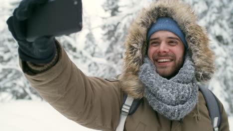 Excursionista-emocionado-tomando-Selfie-en-bosque-del-invierno