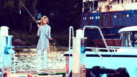 Girl-is-holding-a-fishing-rod-in-her-hands-on-the-pier