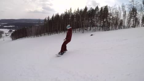 Follow-Shot-of-a-Female-Snowboarder