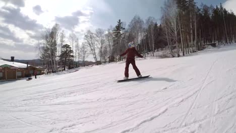 Follow-Shot-of-a-Female-Snowboarder