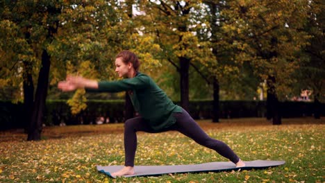 Esbelta-joven-está-haciendo-yoga-al-aire-libre-cambio-asanas-y-disfrutando-el-movimiento,-aire-fresco-y-naturaleza-otoño.-Milenio,-estilo-de-vida-saludable-y-el-concepto-de-recreación.