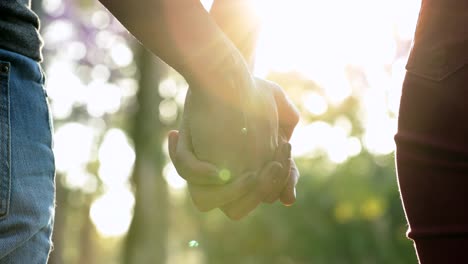 Hands-held-together-with-sunlight-flare-in-the-background