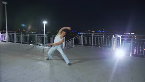 The-guy-dancing-at-night-by-the-light-of-lanterns