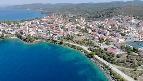 Drone-aerial-view-over-blue-sea-water-on-coast-of-Neos-Marmaras