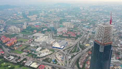 evening-kuala-lumpur-downtown-megatall-construction-traffic-road-aerial-panorama-timelapse-4k-malaysia