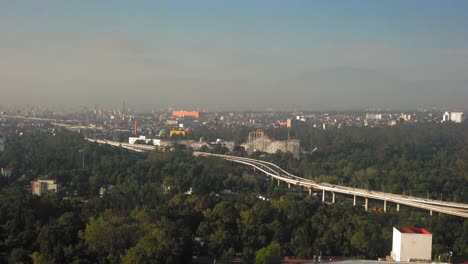 Elevated-view-of-cars-moving-on-elevated-road-leading-towards-city,-Mexico