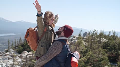 Man-Lifting-Up-Girlfriend-on-Hiking-Trip