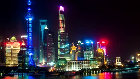 Night-time-lapse-of-the-Huangpu-river,-the-Pudong-financial-business-district,-and-the-Bund,-Shanghai-skyline,-urban-China