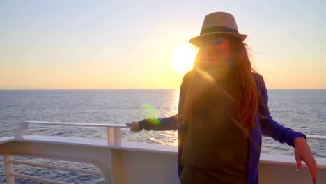 Silhouette-of-young-attractive-woman-watching-sunset-at-cruising-ship-in-the-sea