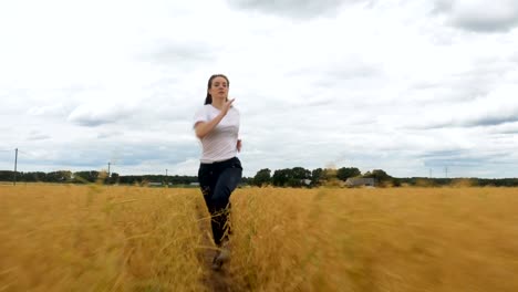 Young-Woman-Runs-Through-a-Golden-Grass-Field-2