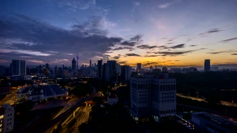 dramatic-sunrise-at-Kuala-Lumpur-city-with-sun-burst-ray.-Moving-and-changing-color-clouds.