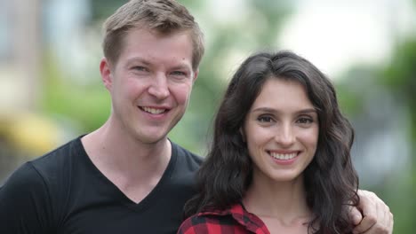 Young-happy-couple-smiling-together-outdoors