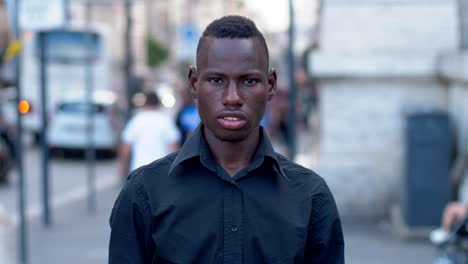 Young-black-African-student-puts-his-backpack-on-his-shoulder---outdoor