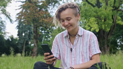 Young-Lady-with-Modern-Hairstyle-Using-Phone-in-Town