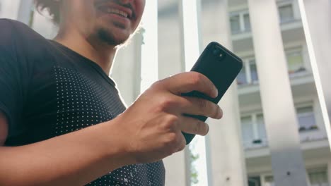 Young-Man-Using-Phone-Outdoors