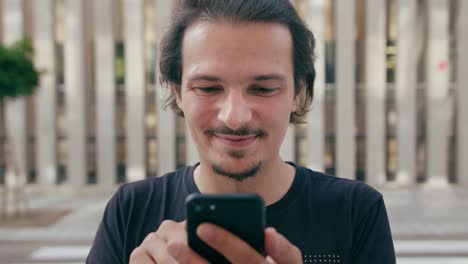 Young-Man-Using-Phone-Outdoors