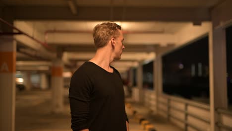 Man-Thinking-Outdoors-At-Night-In-Parking-Lot