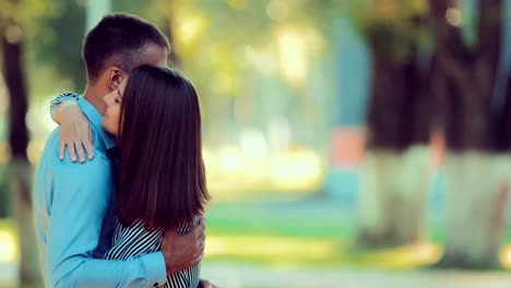 Girl-and-boyfriend-hugging-in-the-park-at-sunset-time