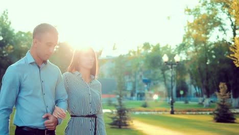 Young-happy-couple-walking-in-beautiful-summer-park