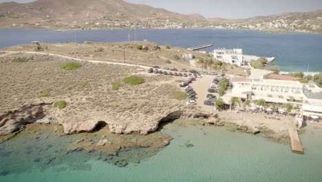 Aerial-view-of-a-young-man-flying-his-drone-at-the-seaside-in-Greece.