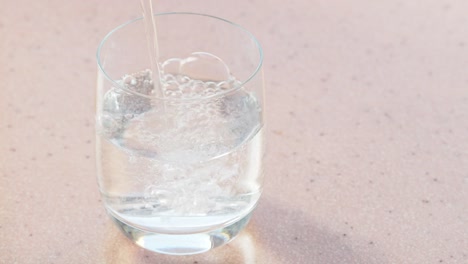 carbonated-mineral-water-pours-in-glass