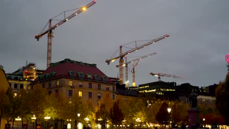 Tall-cranes-with-the-lights-on-in-Stockholm-Sweden