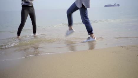 Two-happy-tourists-having-fun-on-seacoast.