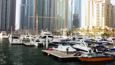 Locked-on-shot-of-boats-docked-at-harbor,-Dubai,-United-Arab-Emirates