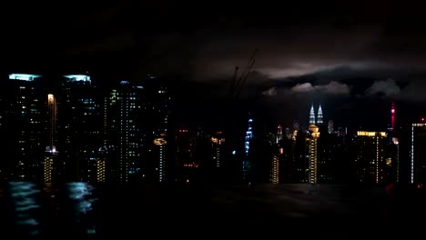 Timelapse-of-night-Kuala-Lumpur,-view-from-rooftop-pool